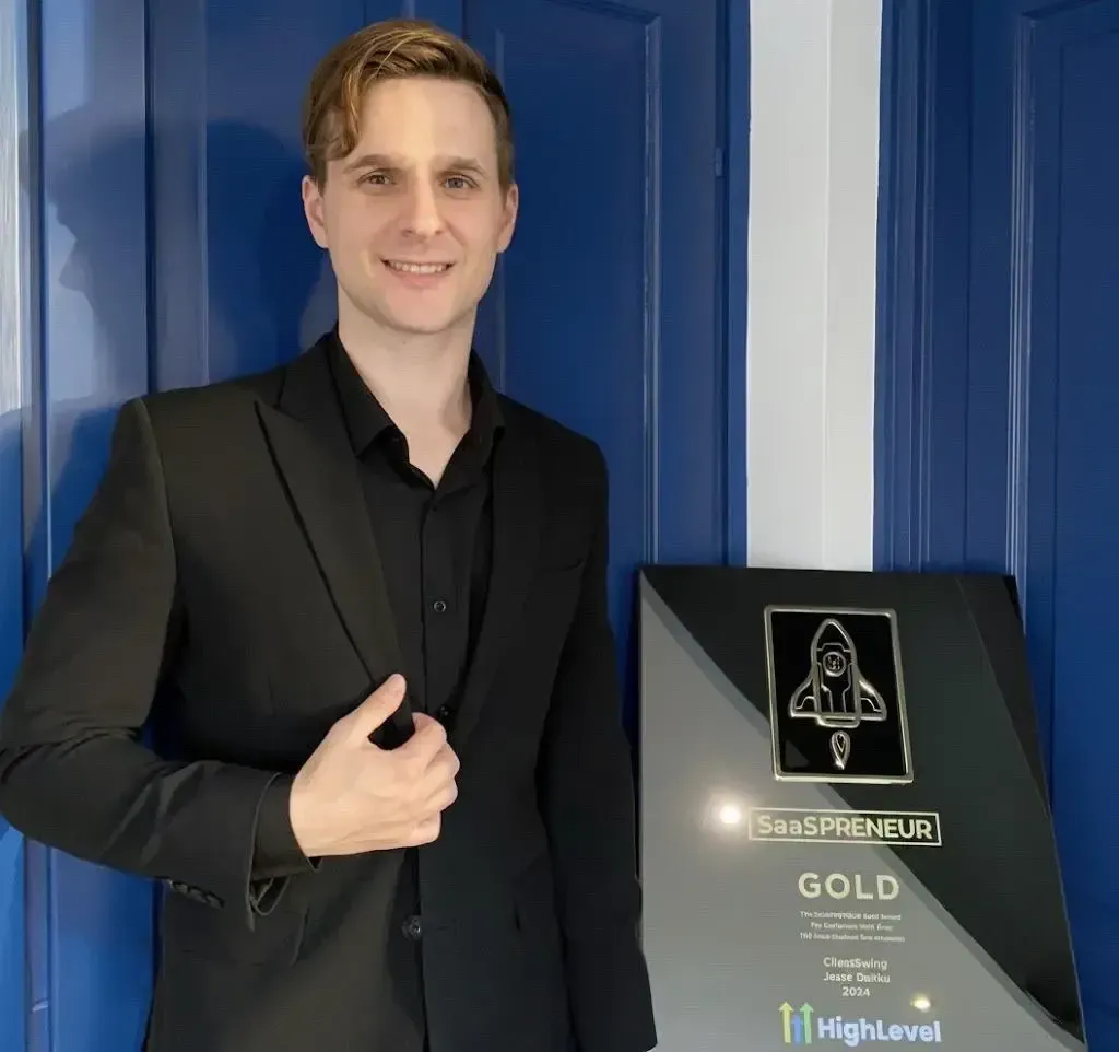 Jesse Danku holding the GoHighLevel SaaSpreneur Gold Award
